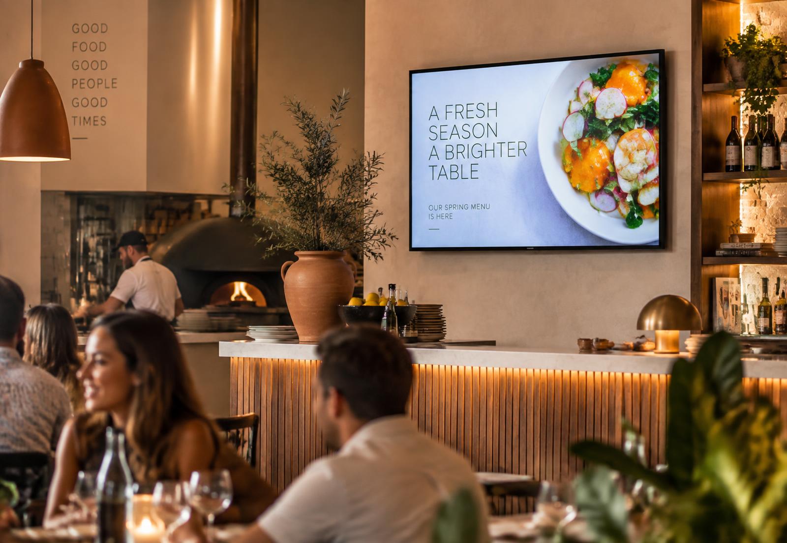 A creative promotion playing on an indoor restaurant screen
